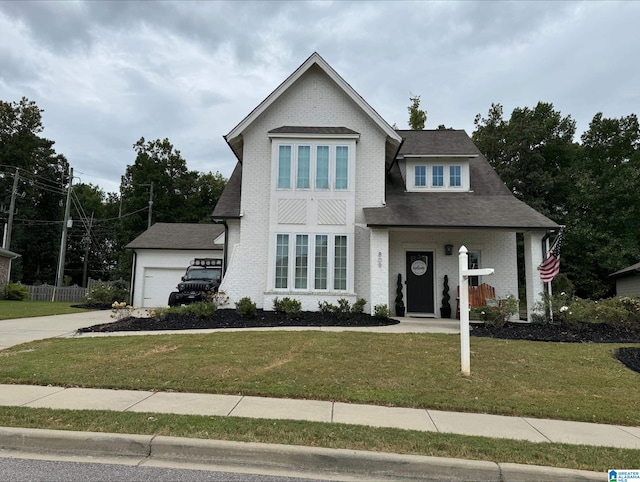 view of front of property featuring a garage and a front lawn