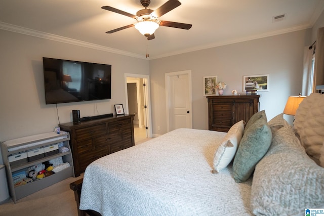 bedroom featuring ceiling fan, carpet floors, and ornamental molding