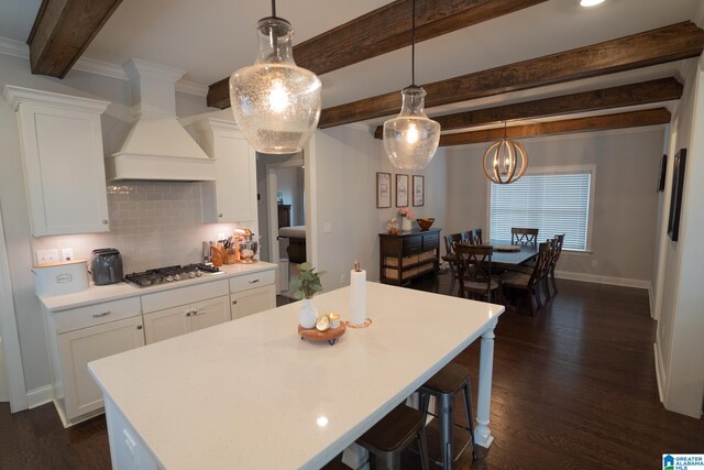 kitchen with pendant lighting, a center island, and white cabinetry