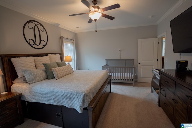 carpeted bedroom with ceiling fan and ornamental molding