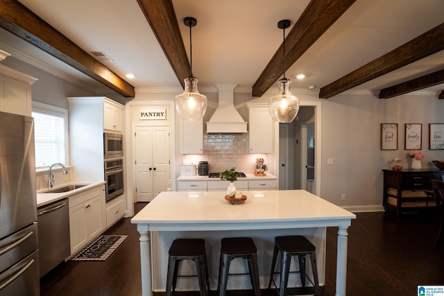 kitchen with premium range hood, sink, appliances with stainless steel finishes, beamed ceiling, and dark hardwood / wood-style flooring