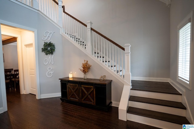 staircase with hardwood / wood-style flooring and a wealth of natural light