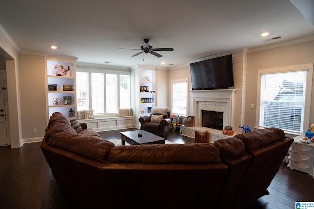 living room with dark hardwood / wood-style floors, a healthy amount of sunlight, and ornamental molding