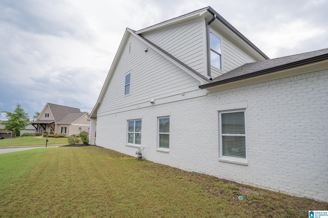 view of side of property with a lawn