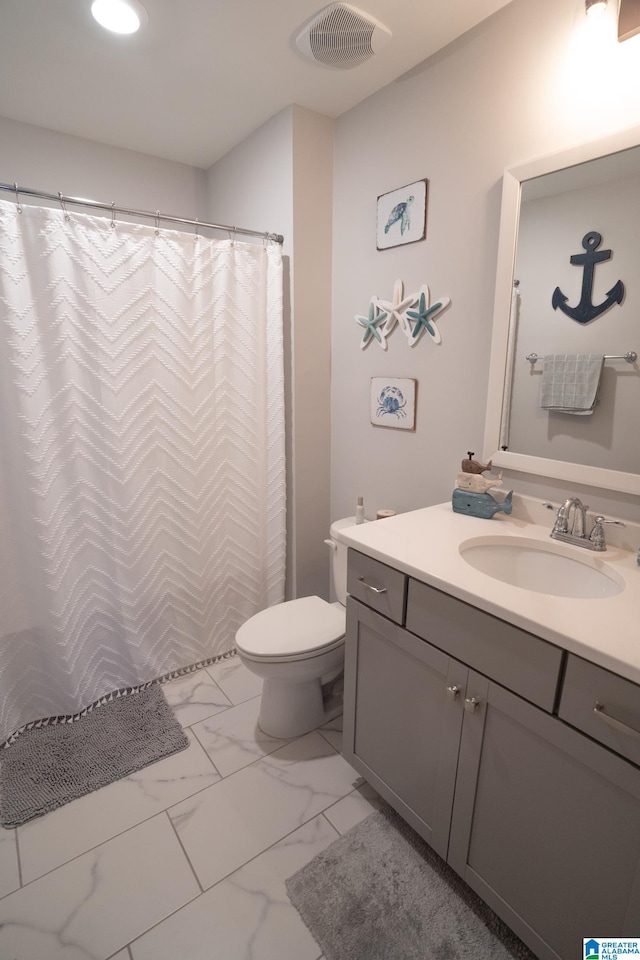 bathroom featuring vanity and toilet