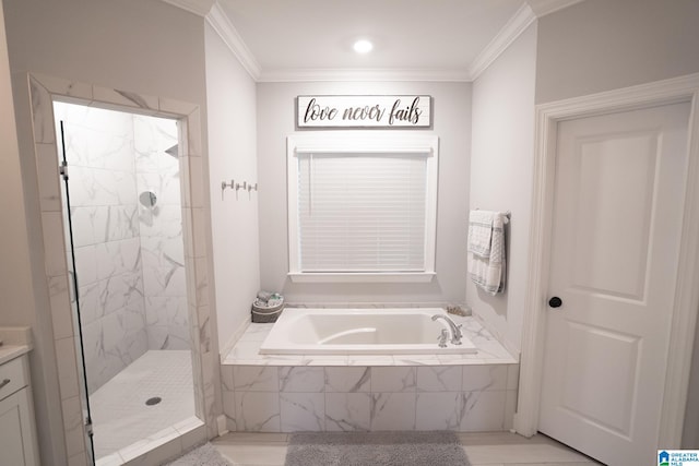 bathroom with crown molding, vanity, and shower with separate bathtub