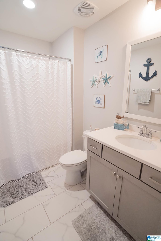 bathroom with vanity and toilet