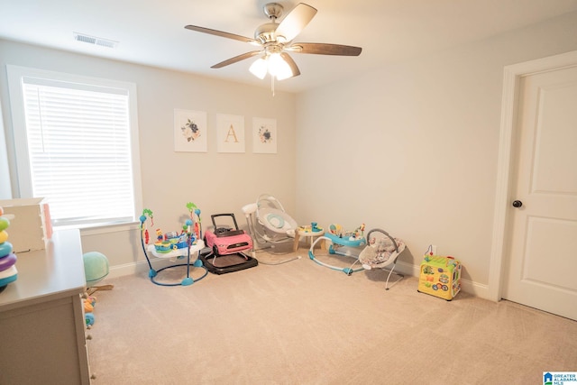 playroom with ceiling fan and light colored carpet