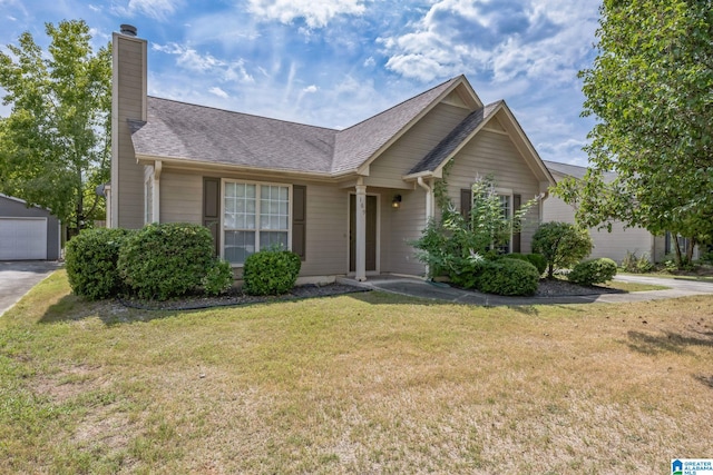 view of front of house with a garage and a front yard