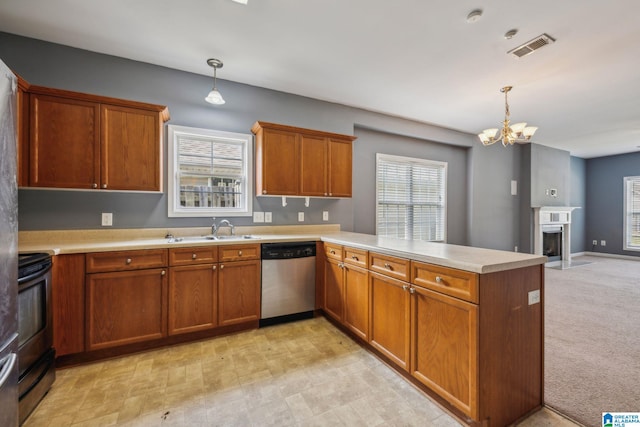 kitchen featuring pendant lighting, black electric range oven, kitchen peninsula, and stainless steel dishwasher