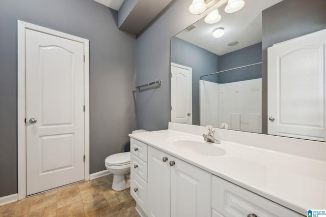 bathroom featuring vanity, toilet, and walk in shower