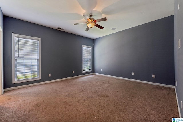 unfurnished room with ceiling fan and carpet floors