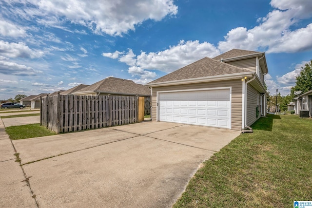 view of side of home with a lawn and a garage