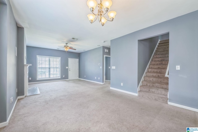 unfurnished room featuring ceiling fan with notable chandelier and light colored carpet