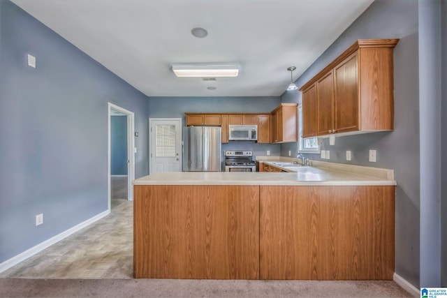 kitchen featuring stainless steel appliances, light carpet, sink, kitchen peninsula, and pendant lighting