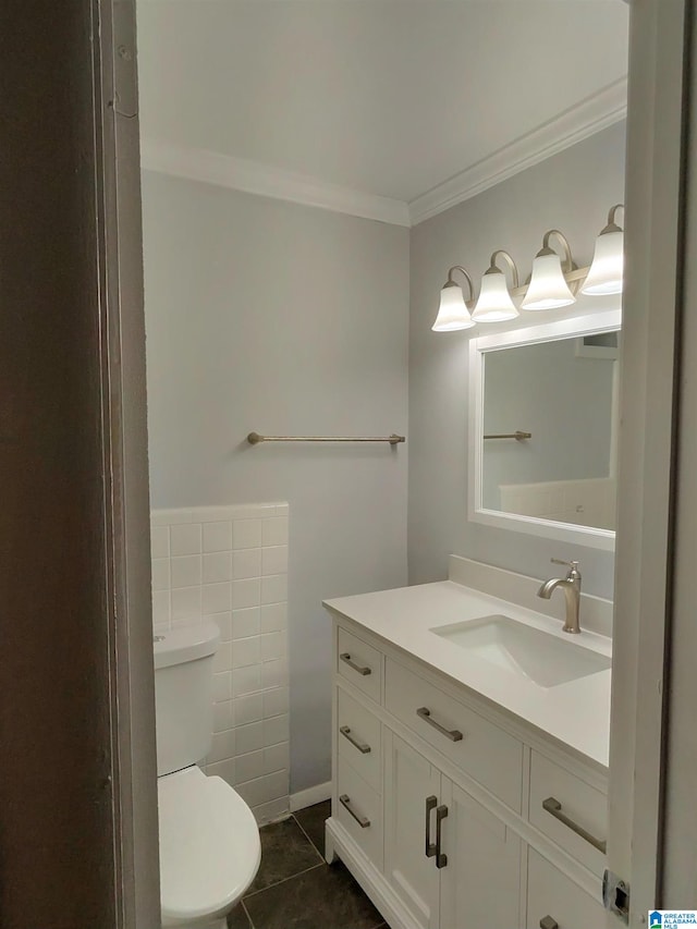 bathroom with vanity, toilet, crown molding, and tile patterned flooring