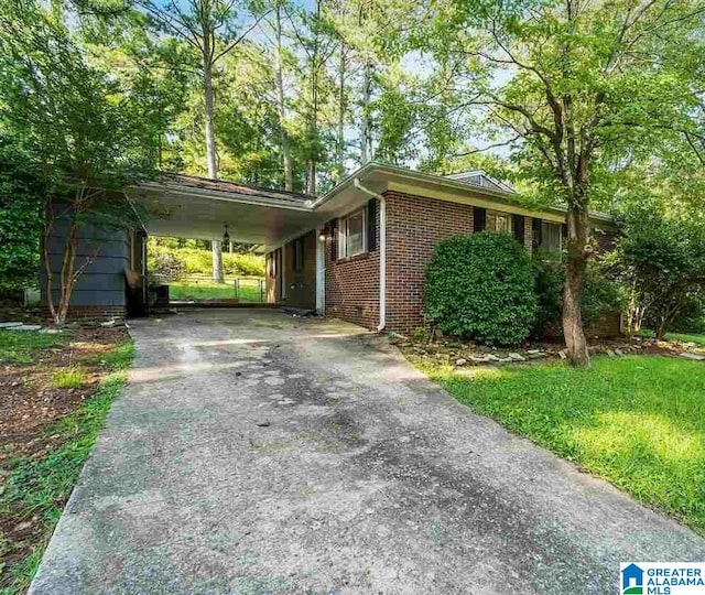 view of side of home with a carport