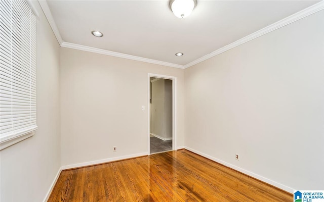 unfurnished room featuring crown molding and wood-type flooring