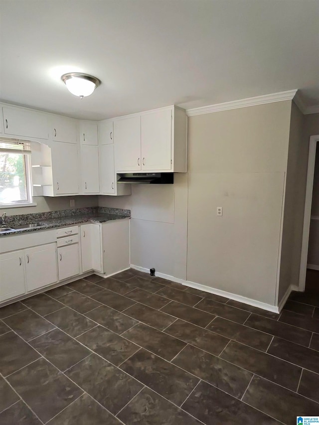 kitchen featuring crown molding, white cabinetry, and sink