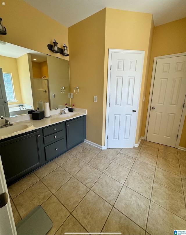 bathroom featuring vanity, a shower with shower door, and tile patterned floors