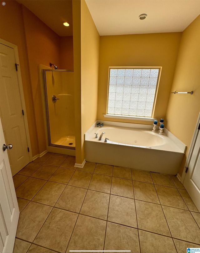 bathroom with independent shower and bath and tile patterned floors