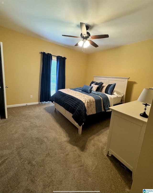 bedroom with ceiling fan and dark colored carpet