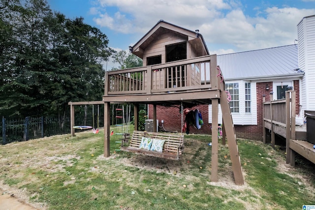 back of house with cooling unit, a yard, and a wooden deck