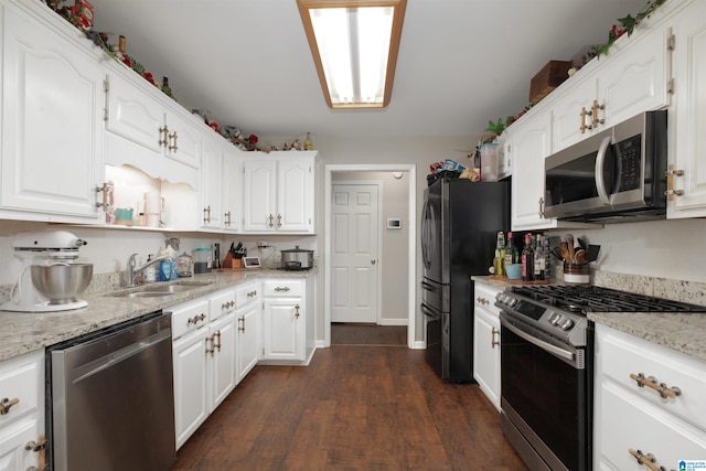 kitchen featuring white cabinets, stainless steel appliances, dark hardwood / wood-style floors, and light stone countertops