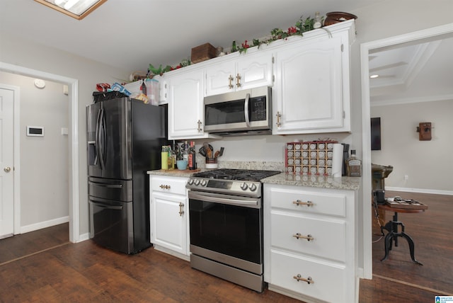 kitchen with ornamental molding, white cabinetry, dark hardwood / wood-style flooring, and stainless steel appliances