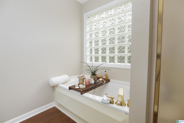 bathroom featuring wood-type flooring and a bathing tub