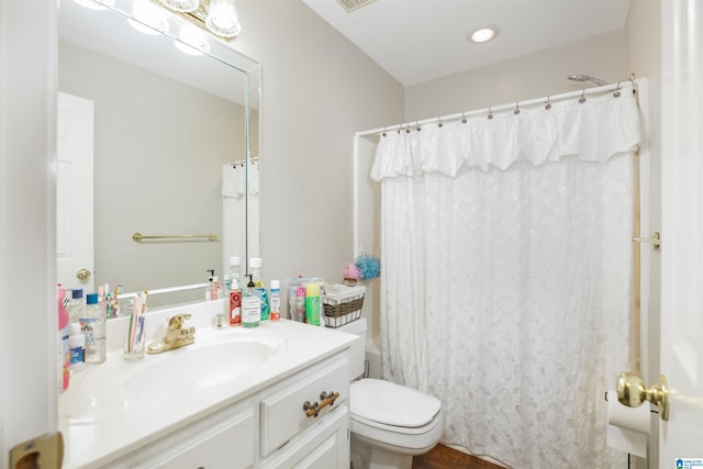 full bathroom featuring vanity, toilet, and shower / bath combination with curtain