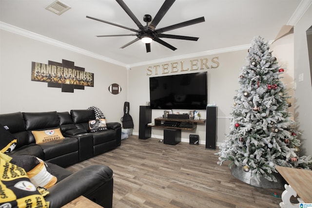 living room with ceiling fan, hardwood / wood-style flooring, and crown molding