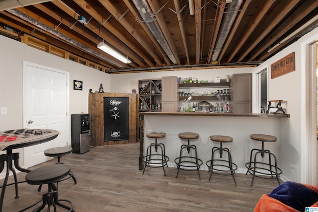 bar with dark wood-type flooring