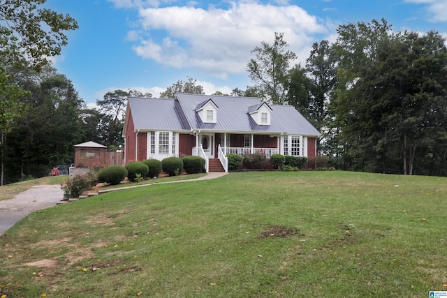 new england style home featuring a front lawn and a porch