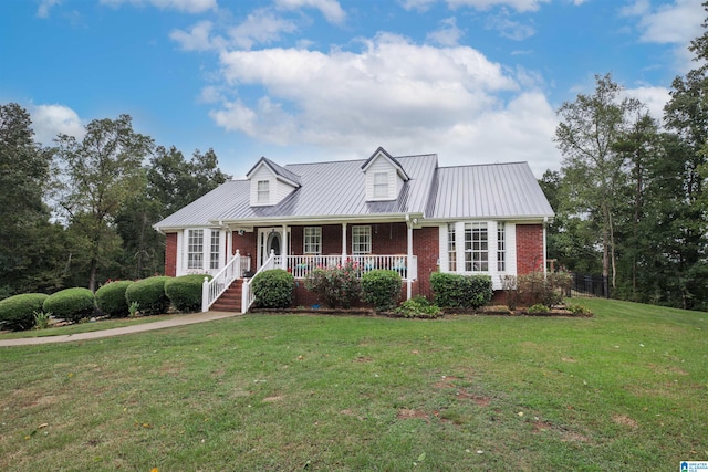 cape cod-style house with a front yard and a porch