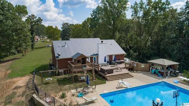 back of property with a patio and a swimming pool side deck