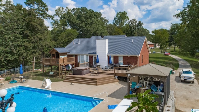 back of property featuring a gazebo, a patio area, and a pool side deck