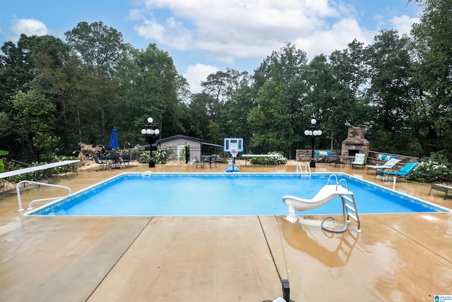 view of pool with a patio and a water slide