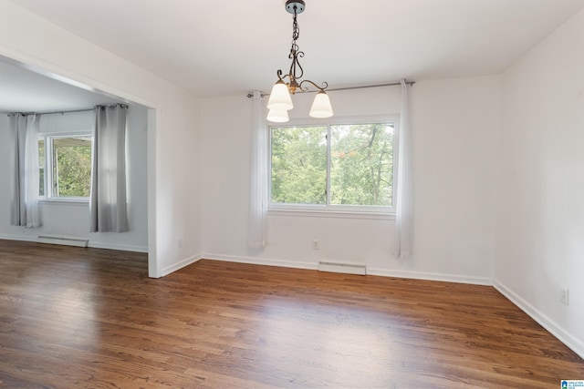 unfurnished room featuring a chandelier, a baseboard radiator, and dark hardwood / wood-style floors