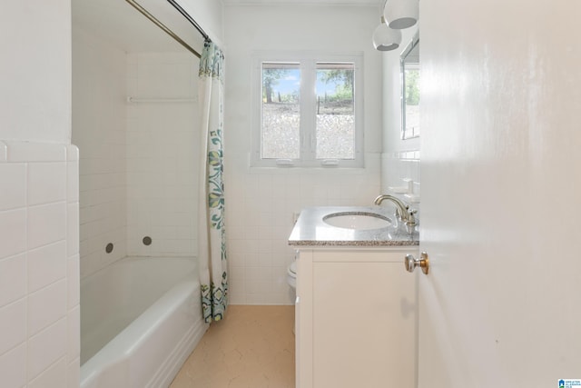 full bathroom with vanity, toilet, shower / tub combo with curtain, and tile walls