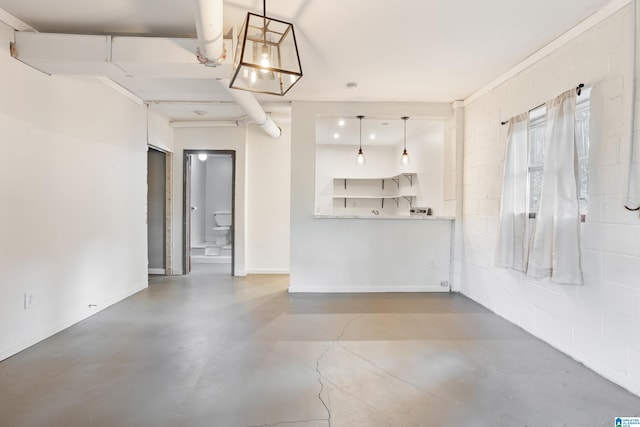 unfurnished living room featuring concrete floors