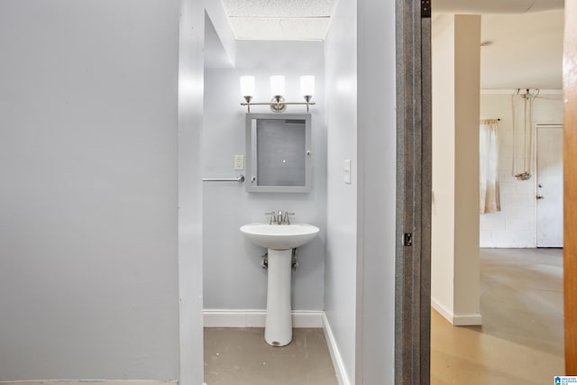 bathroom featuring concrete flooring and sink