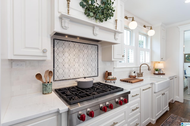 kitchen featuring white cabinets, stainless steel gas stovetop, decorative backsplash, and dark hardwood / wood-style floors