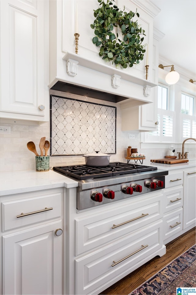 kitchen with white cabinets, stainless steel gas cooktop, dark hardwood / wood-style flooring, and tasteful backsplash