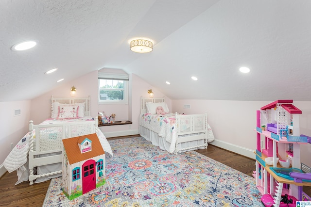 bedroom with lofted ceiling, hardwood / wood-style flooring, and a textured ceiling