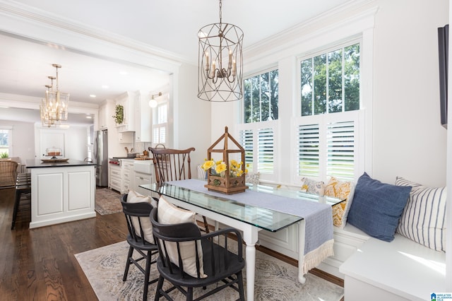 dining area with dark wood-type flooring, plenty of natural light, and a notable chandelier