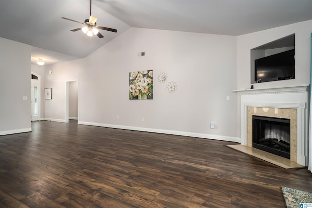 unfurnished living room with ceiling fan, dark wood-type flooring, a premium fireplace, and high vaulted ceiling