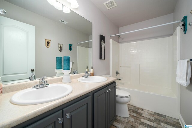 full bathroom featuring  shower combination, vanity, and toilet