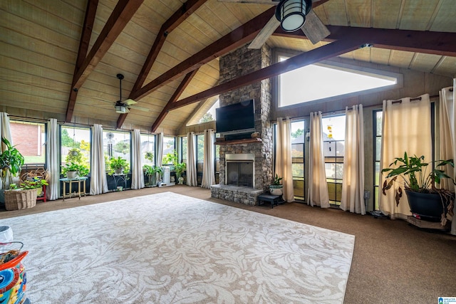 unfurnished living room featuring ceiling fan, beamed ceiling, carpet flooring, wooden ceiling, and a fireplace