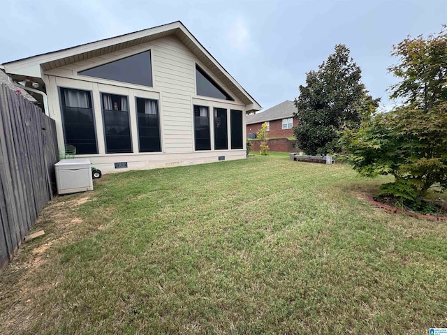 back of house featuring a yard